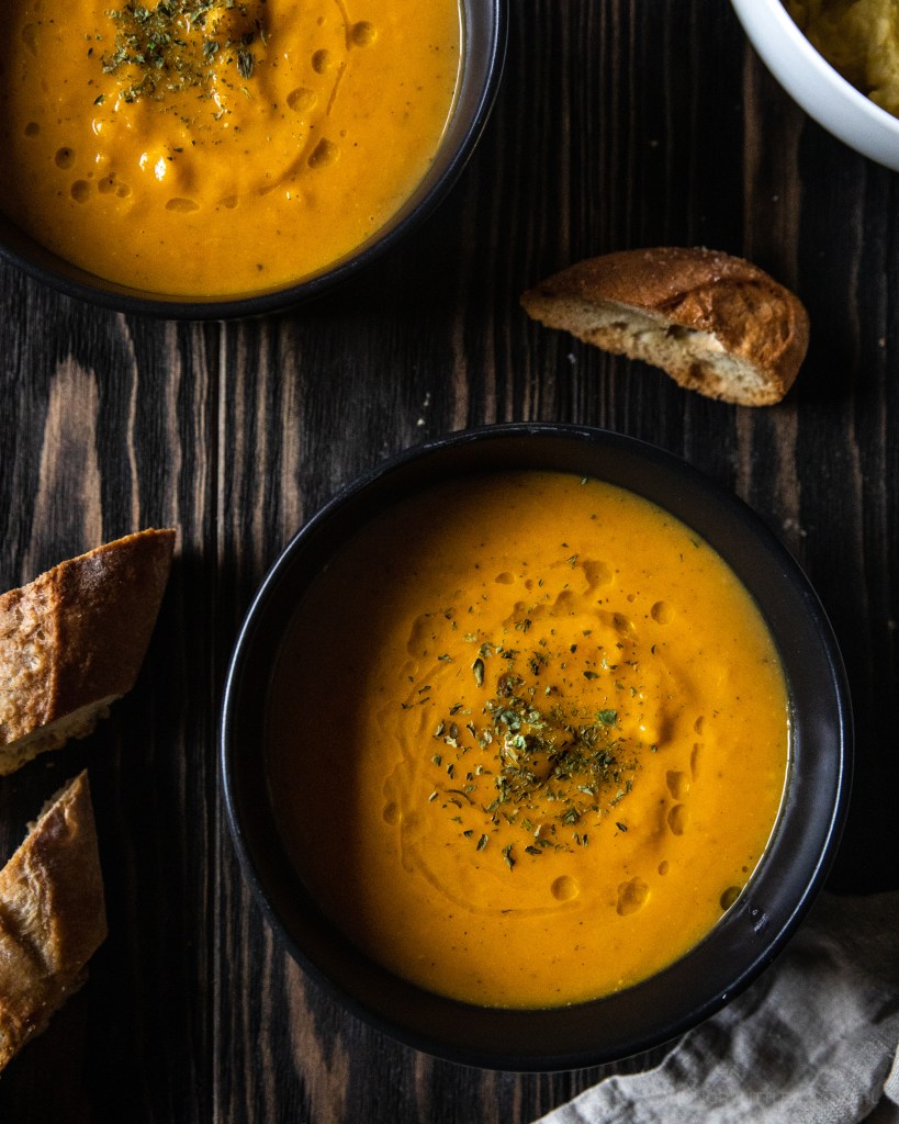 bowls of butternut squash soup with bread